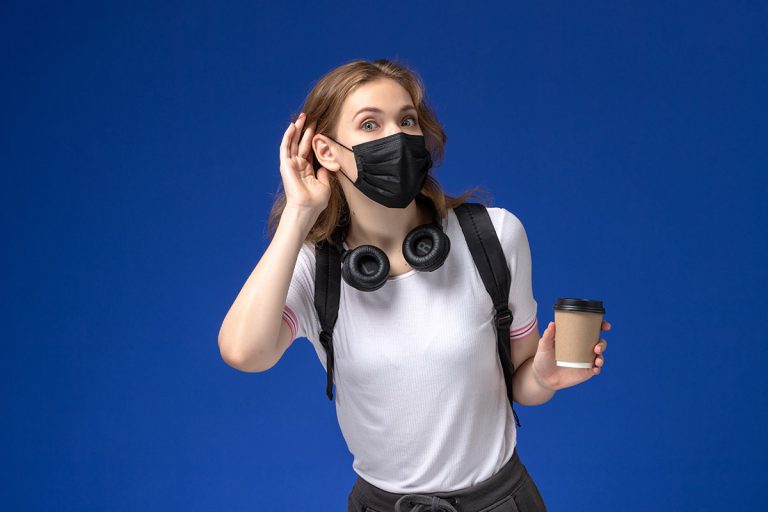 girl-student-black-mask-holding-coffee-trying-hear