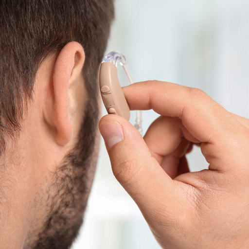 man-putting-hearing-aid