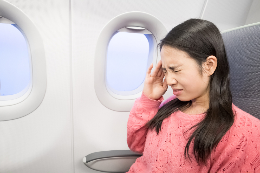 middle-aged-women-feel-headache-airplane-630092396